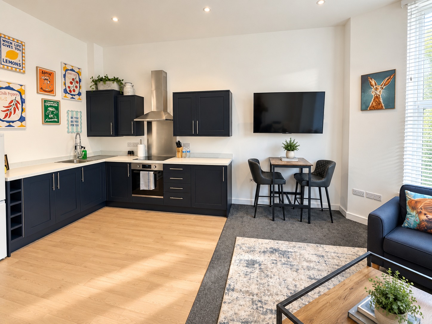 Luna kitchen and dining area with dark cabinetry and wall-mounted television